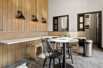 a dining room with a table and chairs and a counter